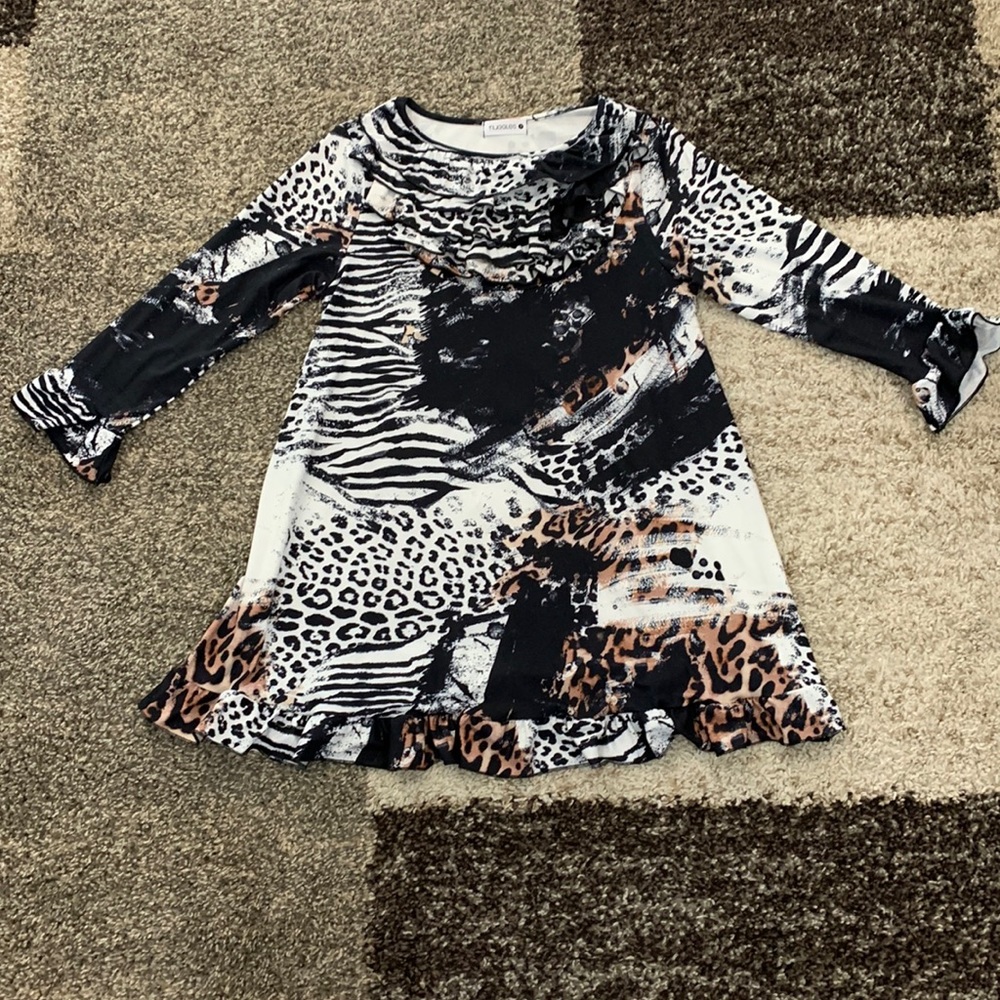Nuggles brand animal print top with ruffles at the neck line. Mint condition.